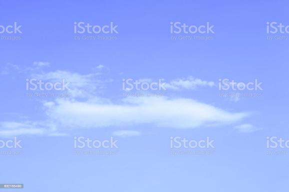 An airplane flying in the sky with clouds royalty - free.