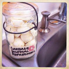 A jar filled with peeled bananas sitting on top of a sink.