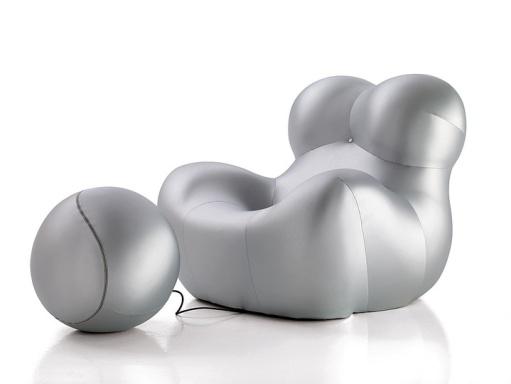 An inflatable chair and foot rest with two balls.