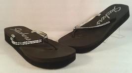 Black flip flops with rhine straps and silver trim.